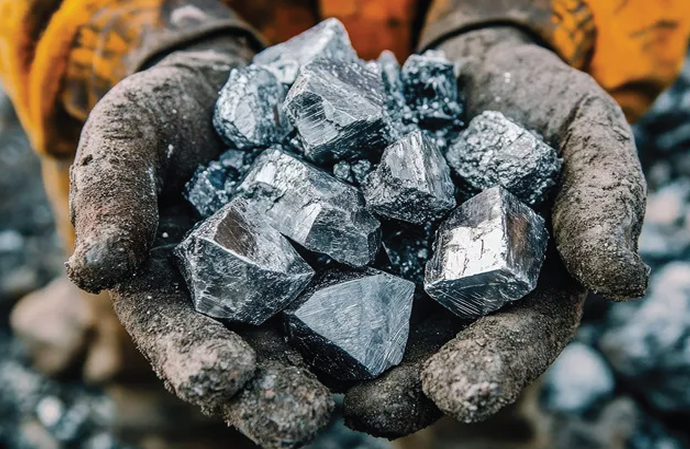 Gloved hands holding chunks of minerals